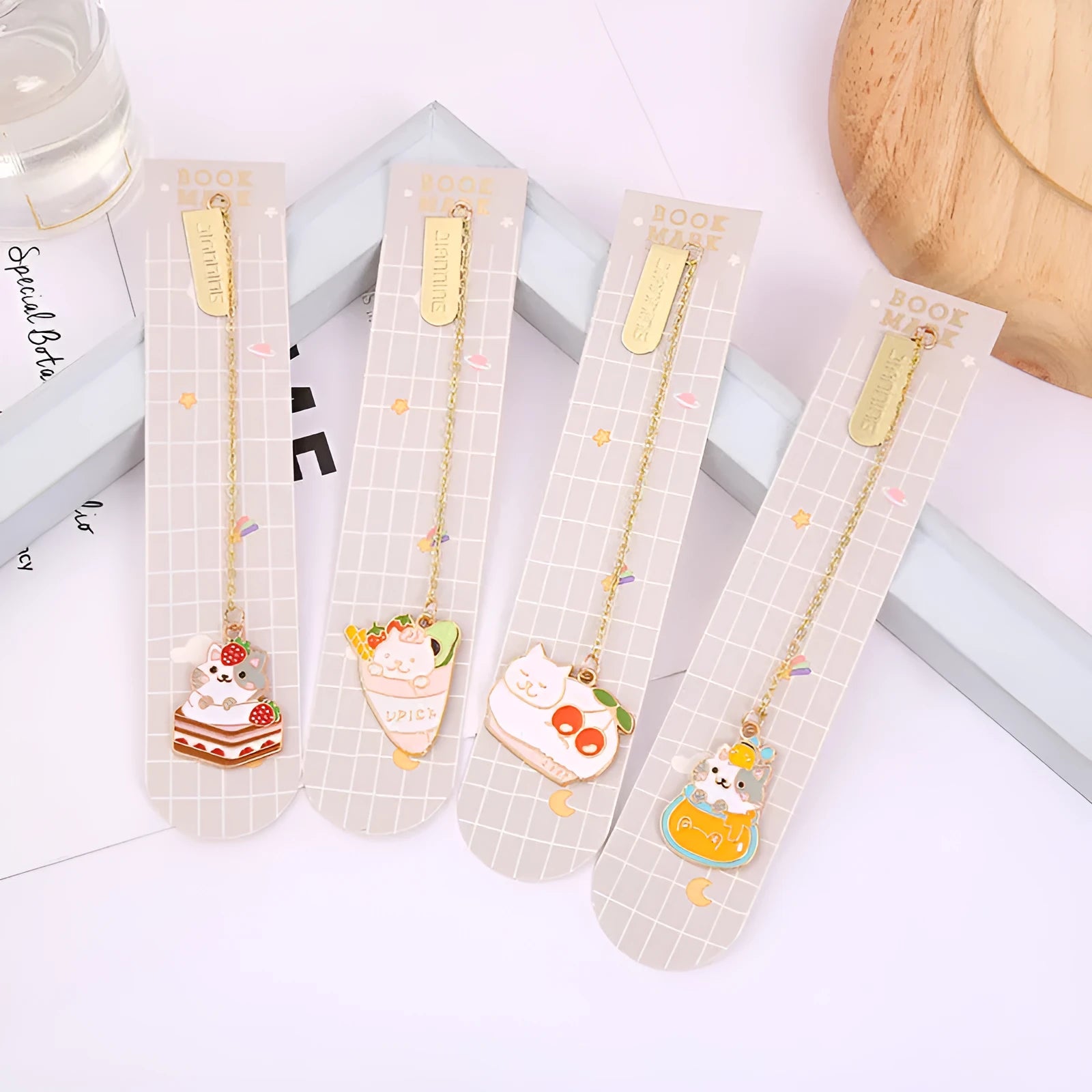 Metal bookmark with cartoon cat pendant in one of four designs measuring 3.8cm by 18.3cm