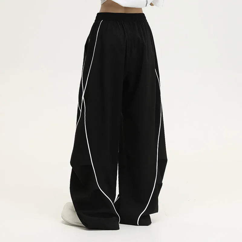 Black striped hip hop sports trousers with pleated wide-leg design on a mid waist