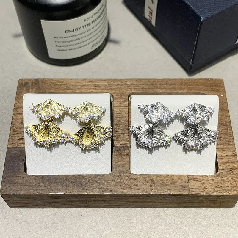 Minimalist irregular zircon stud dangle earrings in gold colour on a white background