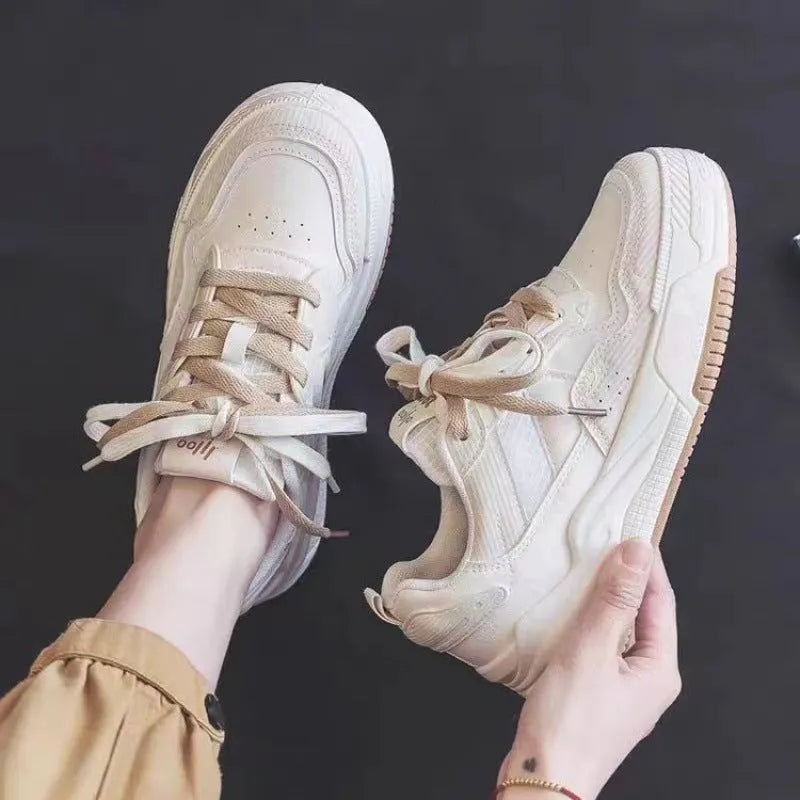 Beige and pink low-top platform sneakers with a rubber sole on a white background
