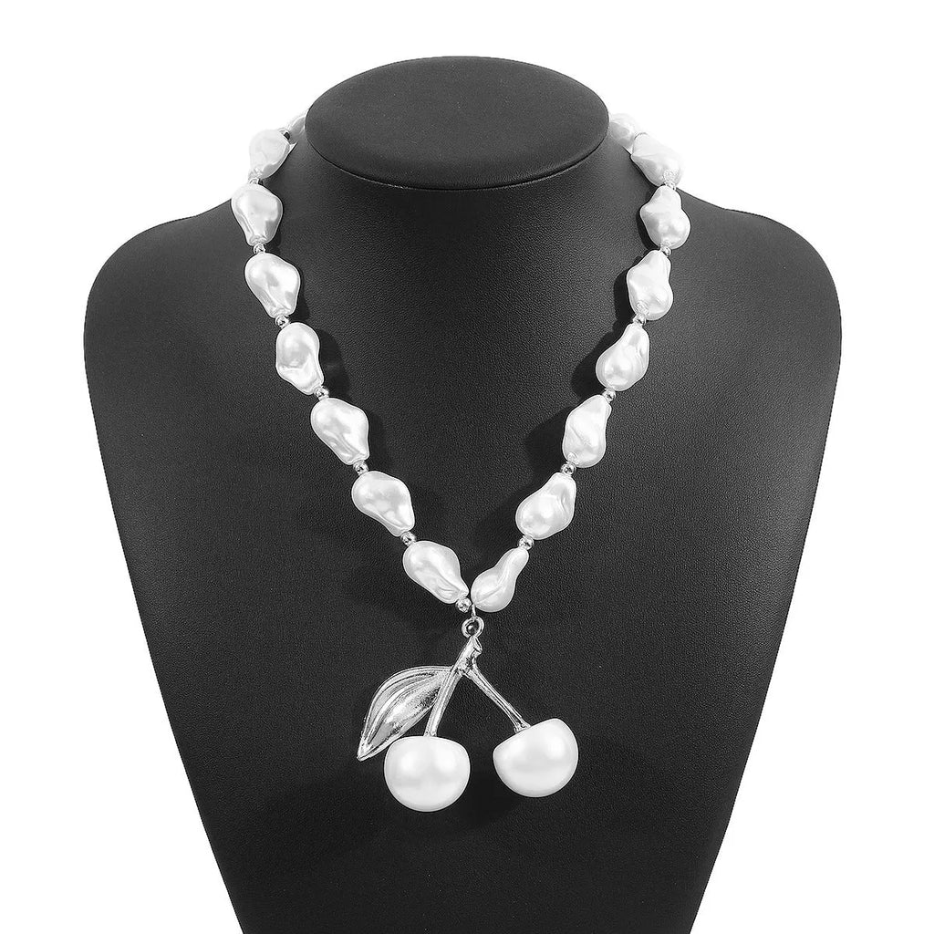 Geometric fruit pendant necklace with pearl chain in gold finish, measuring 51-60cm circumference