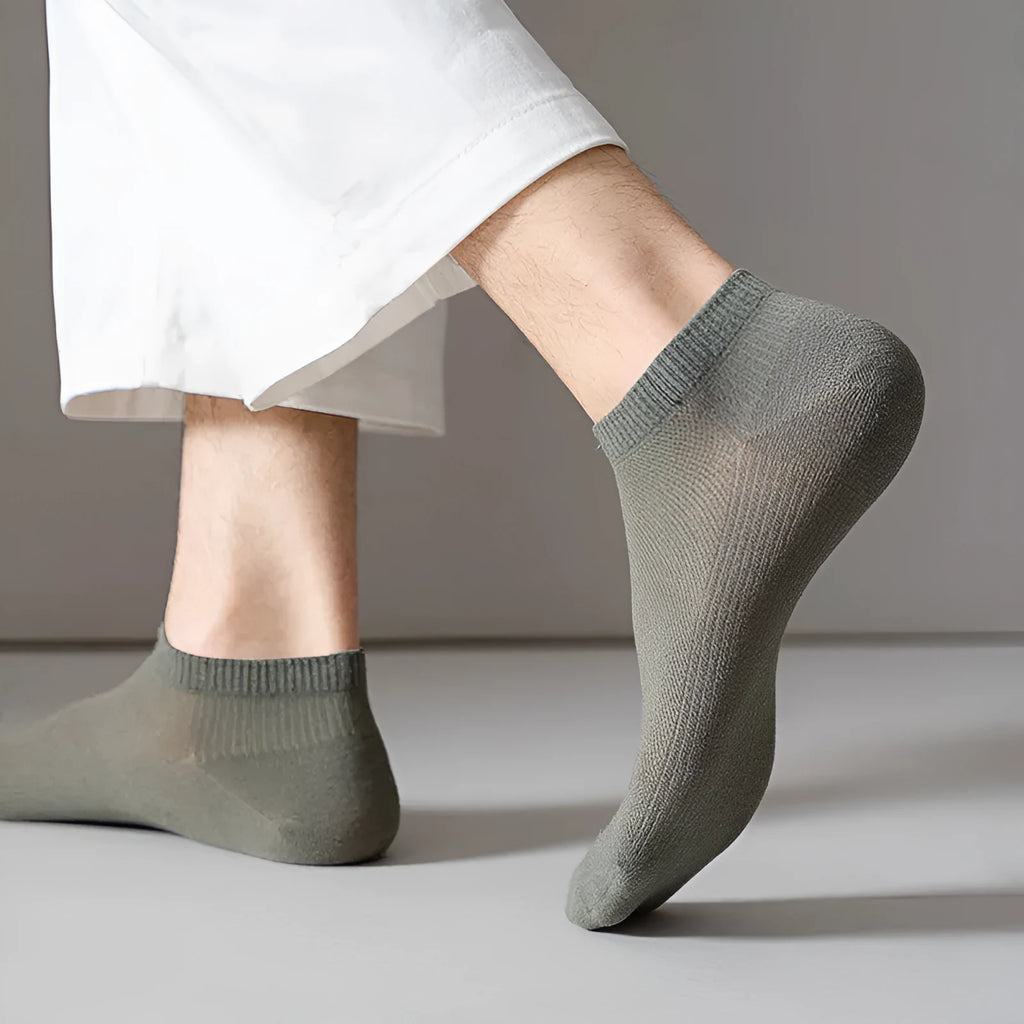 A pair of solid colour low-cut boat socks made from breathable polyester, shown in one of six available colour options.