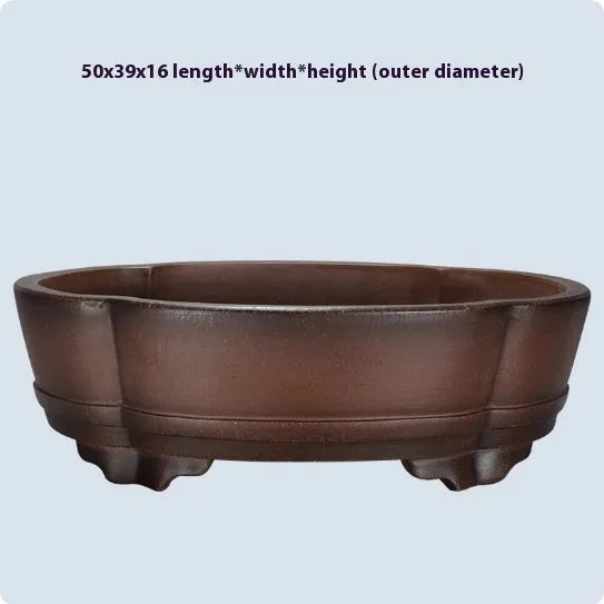 A classical simple purple clay bonsai pot on a tabletop.