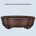 A classical simple purple clay bonsai pot on a tabletop.
