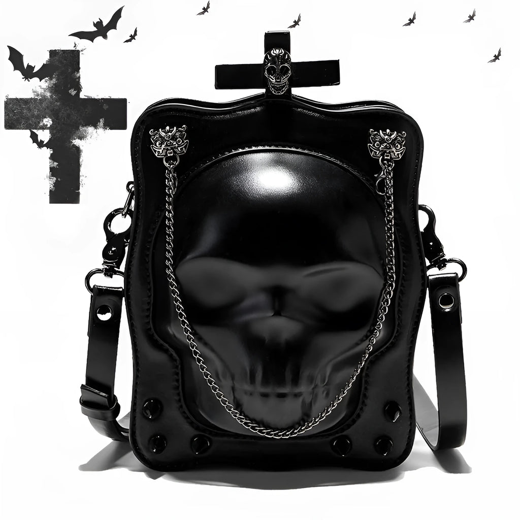 Black mini square crossbody bag with skull embossing, chain detail, and metal rivets on a vertical PU leather messenger bag.