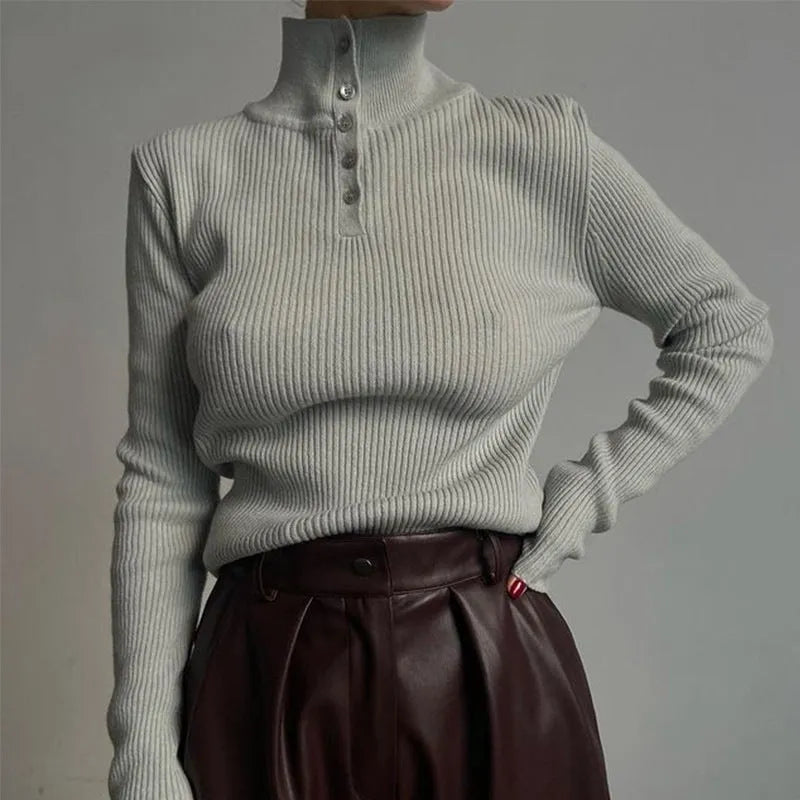 Women's silver grey slim fit pullover sweater with a half turtleneck and single-breasted placket on a hanger.