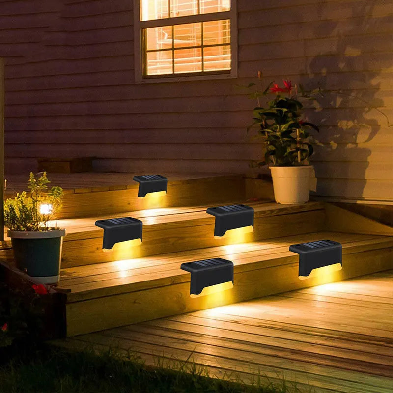 Solar garden stair light in black with warm light, compact ABS housing for outdoor courtyard use