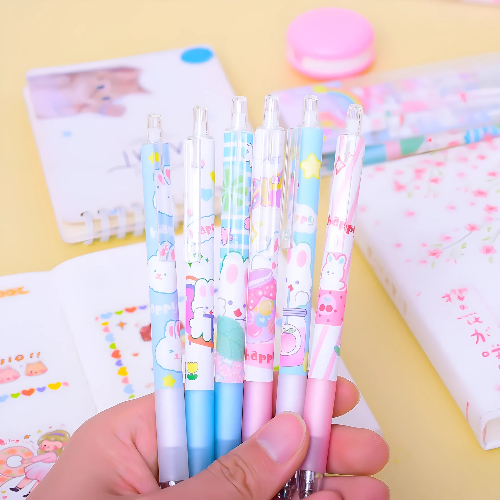 Six black plastic pens with cartoon bunny design and 0.5mm fine tips in an open box.