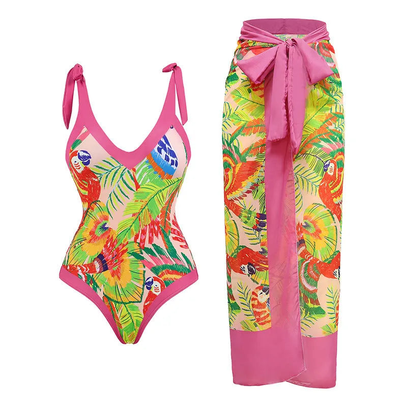 Pink floral print one-piece swimsuit with V-neck, covered belly, and an attached skirt.