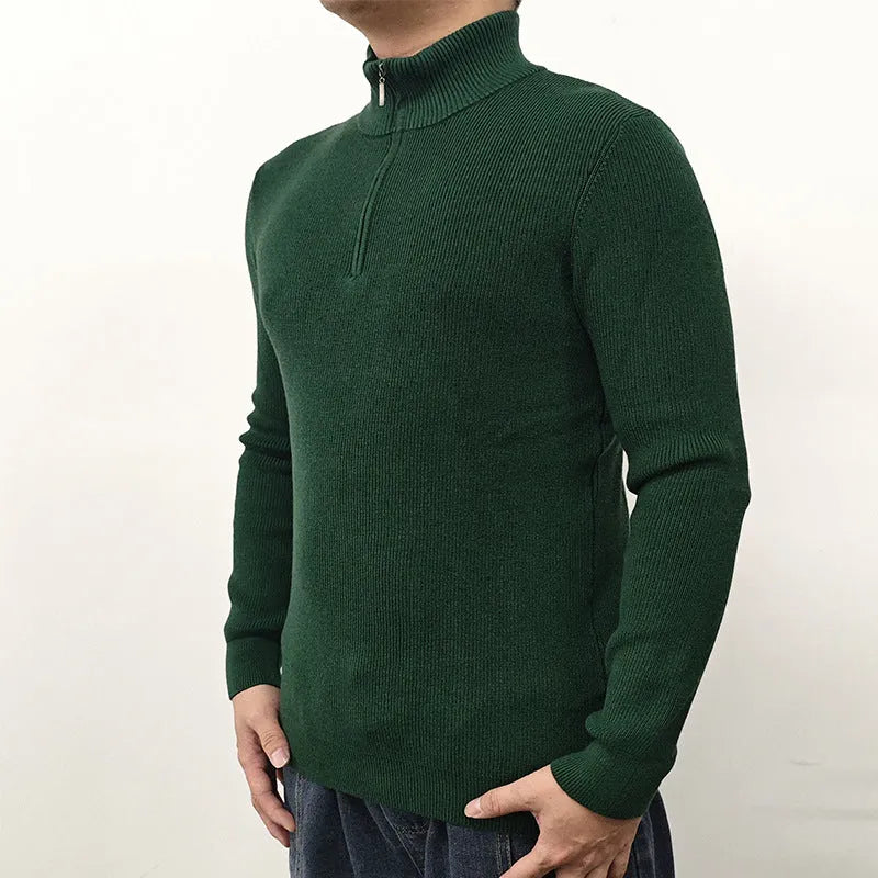 Man wearing a grey half-turtleneck zipper sweater, a cotton blend pullover for casual wear.