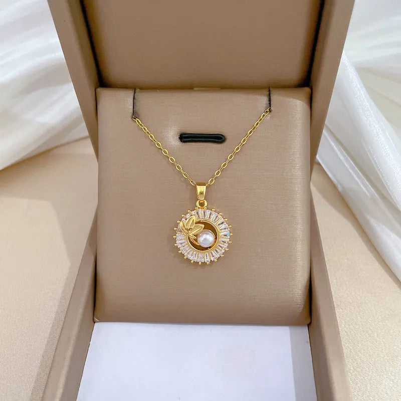 Square geometric necklace with diamond and leaf design alongside matching stud earrings