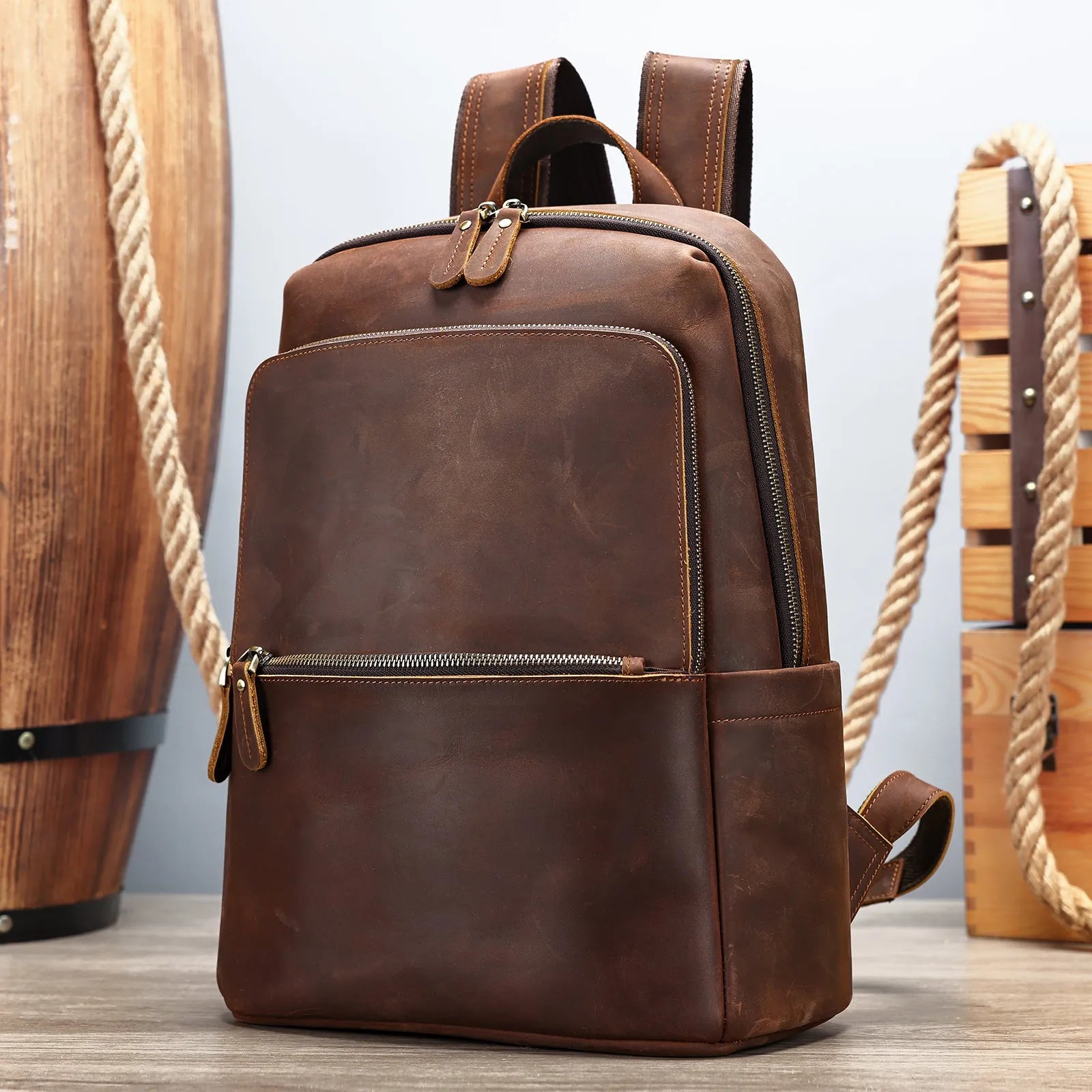 Men's genuine leather backpack in black, first layer cowhide, with a top handle and zipped main compartment