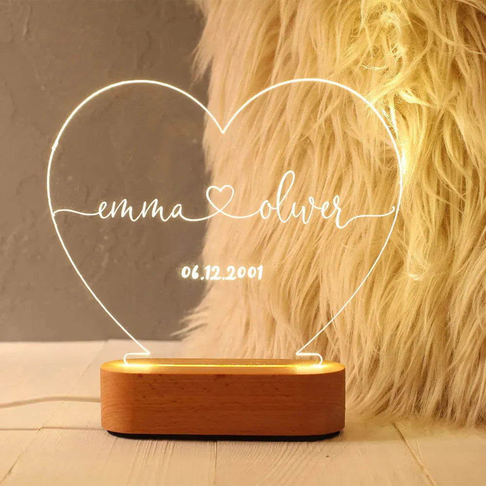 Custom engraved acrylic LED night light showing illuminated personal names and dates
