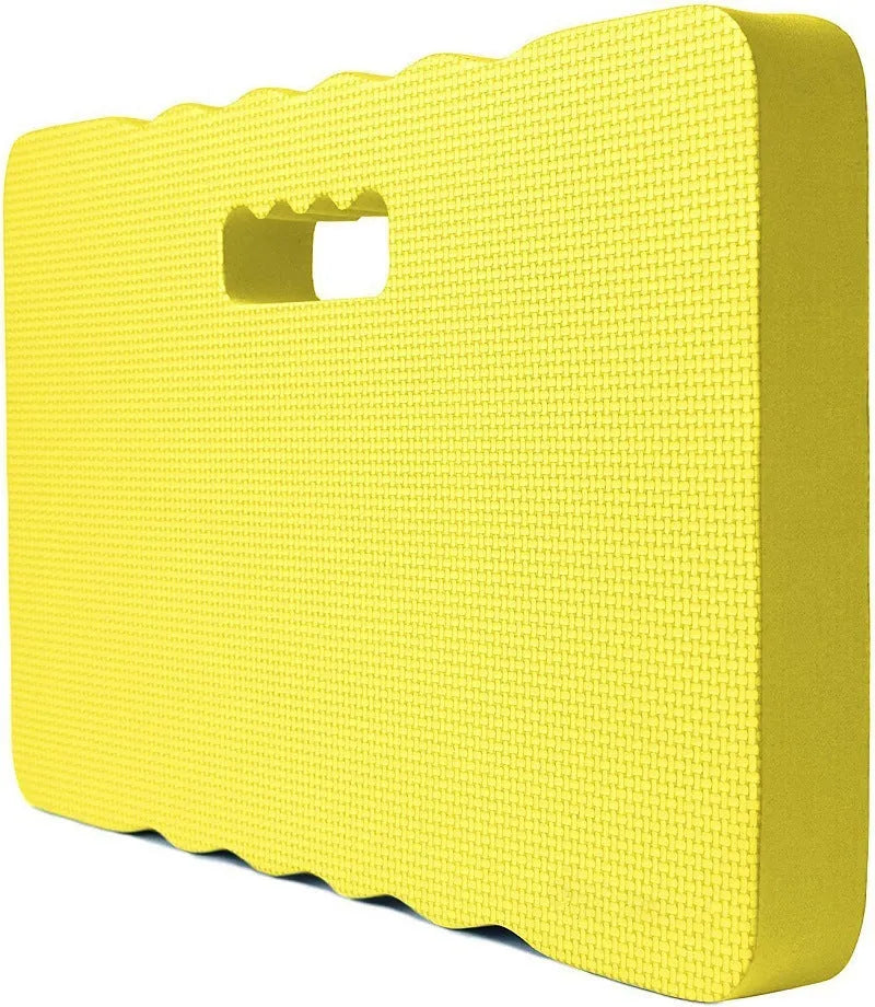 Blue garden kneeler pad with thick foam cushioning on soil next to plants