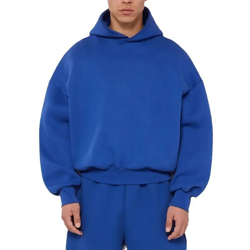 A man's grey fleece-lined cotton pullover hoodie on a hanger.