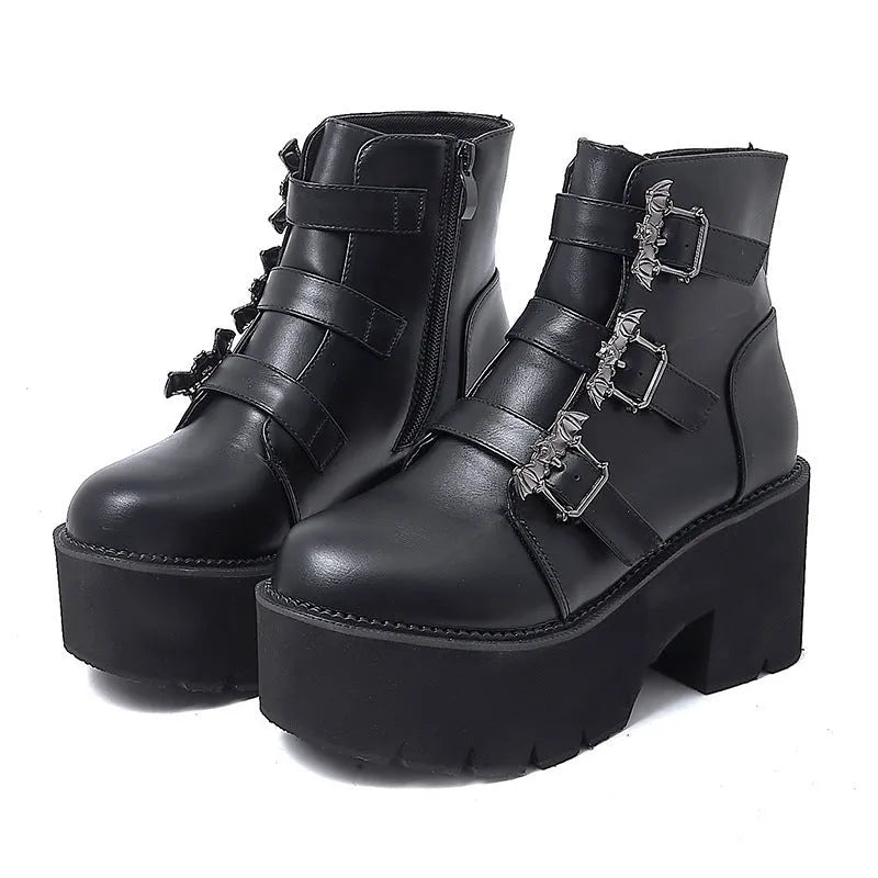 Black women's gothic punk ankle boots with a large bat-shaped buckle and a side zipper.