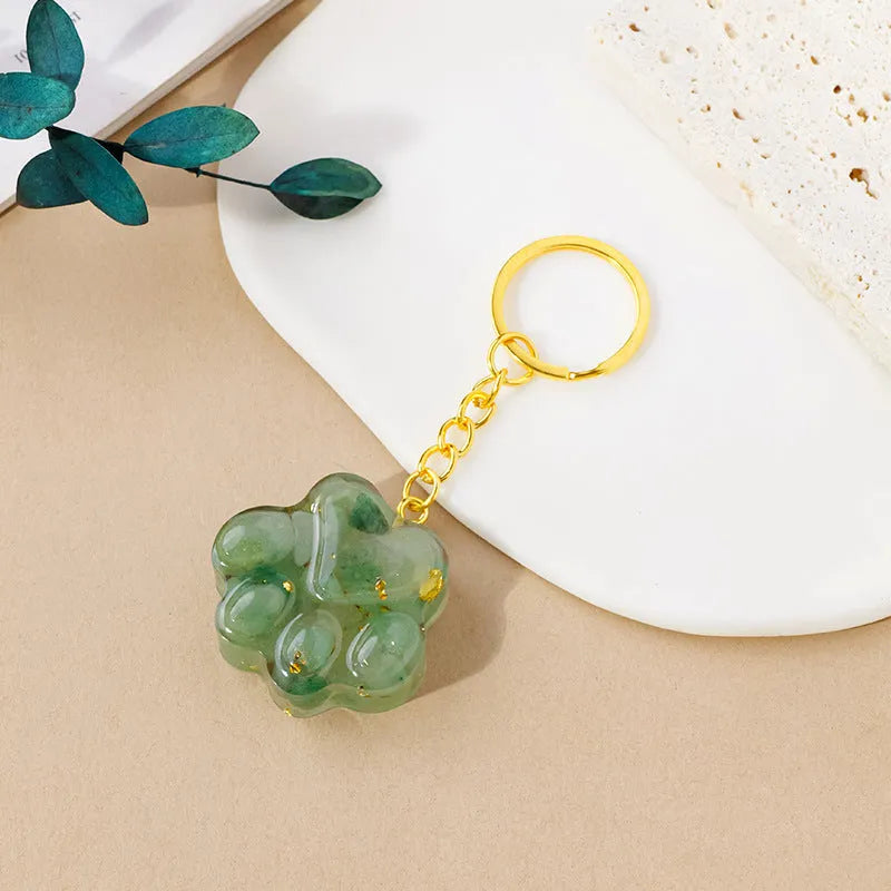 Small natural crystal cat's paw shaped pendant on a metal keyring, available in various crystal colours.