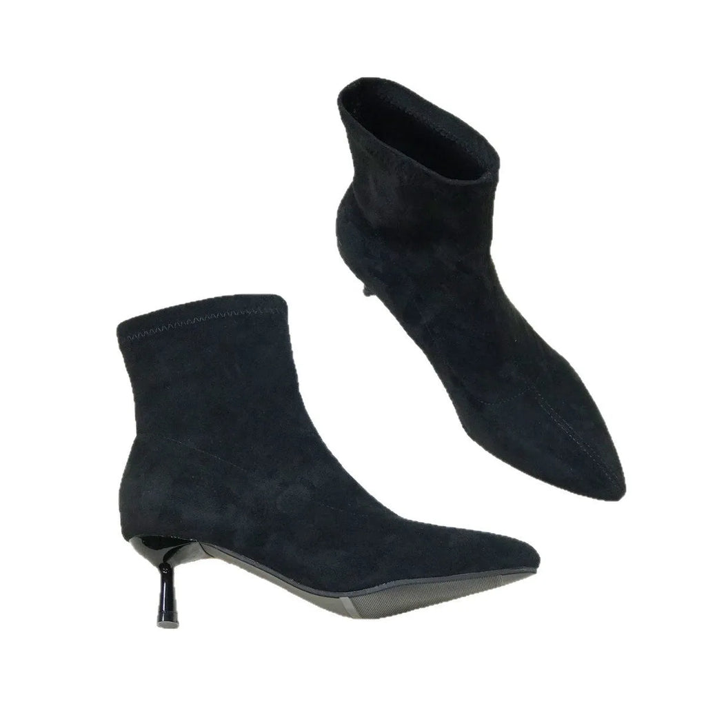 Women's black pointed toe ankle boots with a stiletto heel and mid-calf sock length.