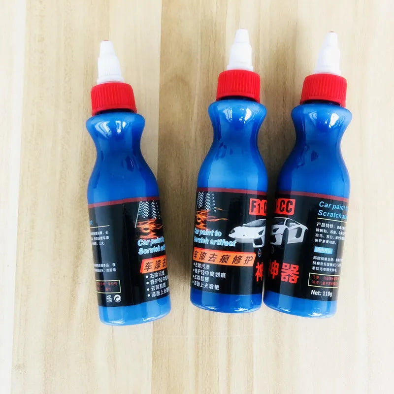 Small blue automotive scratch repair agent bottle with wiping tool for car paint scratch removal