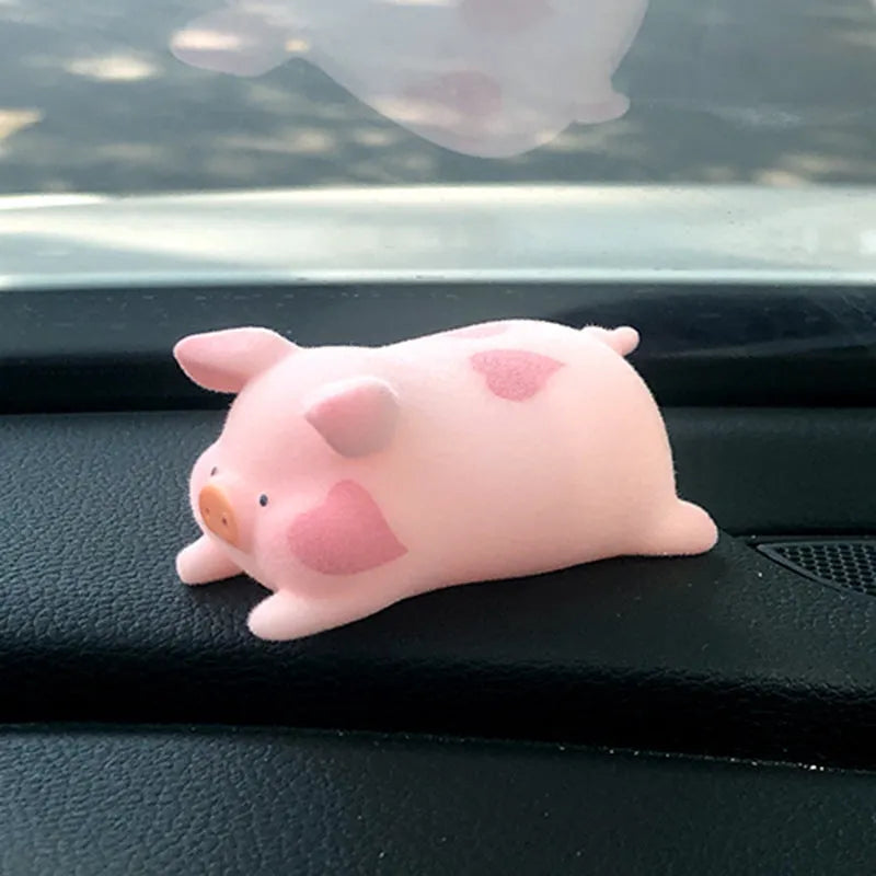 A cute resin cartoon pig figure car accessory for dashboard decoration.