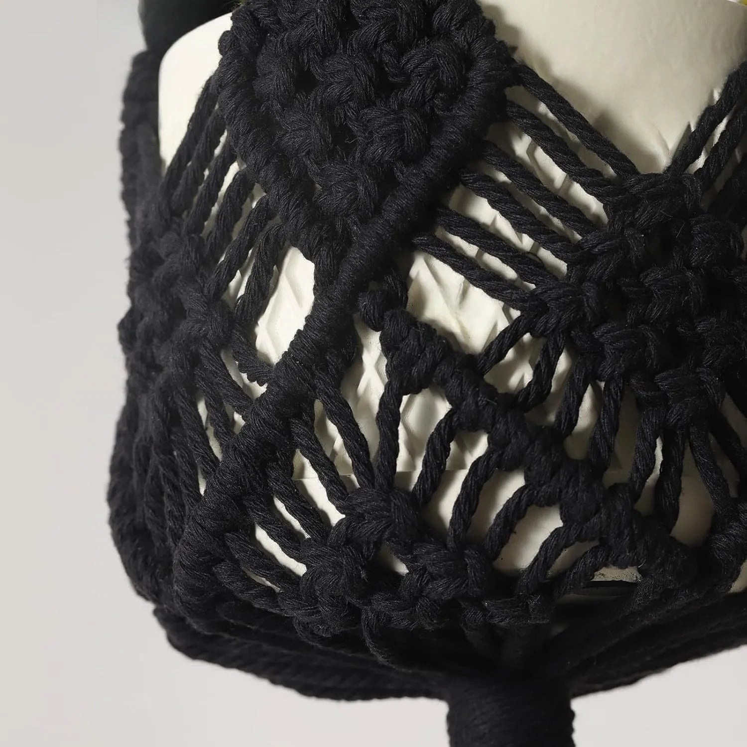 Handwoven brown polyester cotton flower pot net sleeve covering a plant pot.
