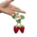 Handmade woven strawberry-shaped car hanging ornament made from cotton and hemp yarn with a Lily of the Valley hook.