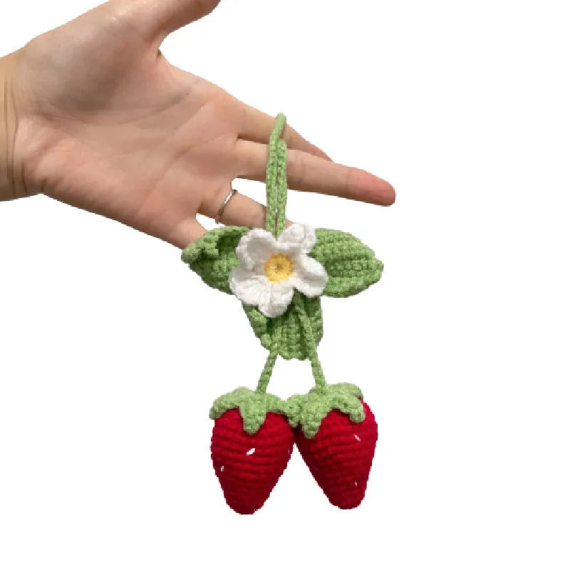 Handmade woven strawberry-shaped car hanging ornament made from cotton and hemp yarn with a Lily of the Valley hook.