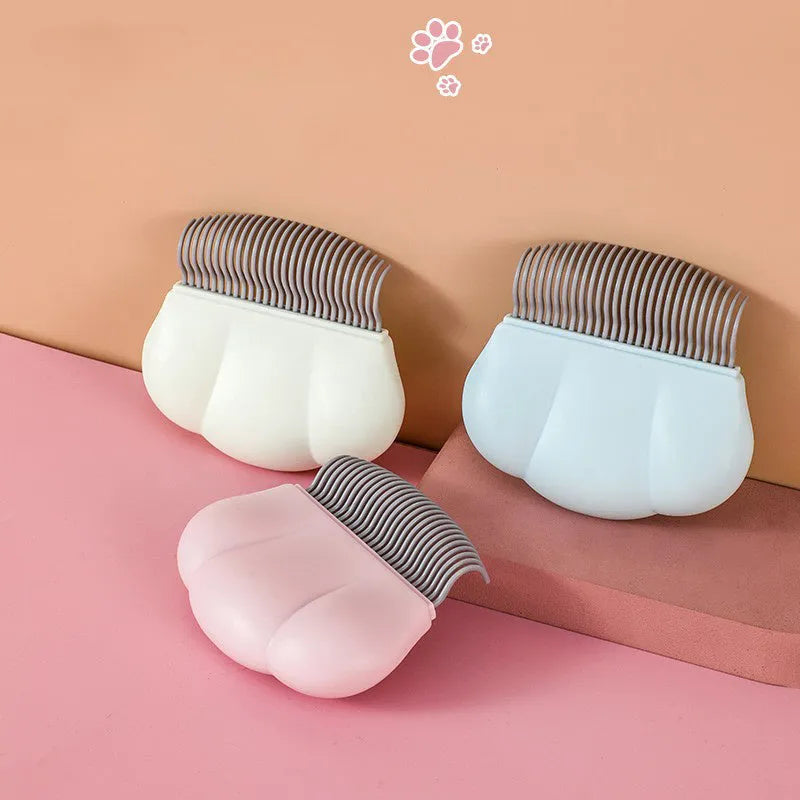 Paw Soft deshedding brush for pets in blue, pink, or white with anti-slip handle