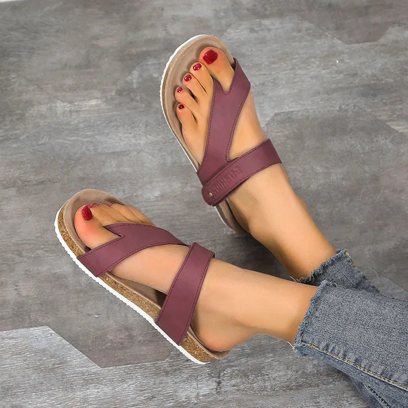 A pair of flat toe ring thick-soled flip-flops in a solid colour on a plain background.