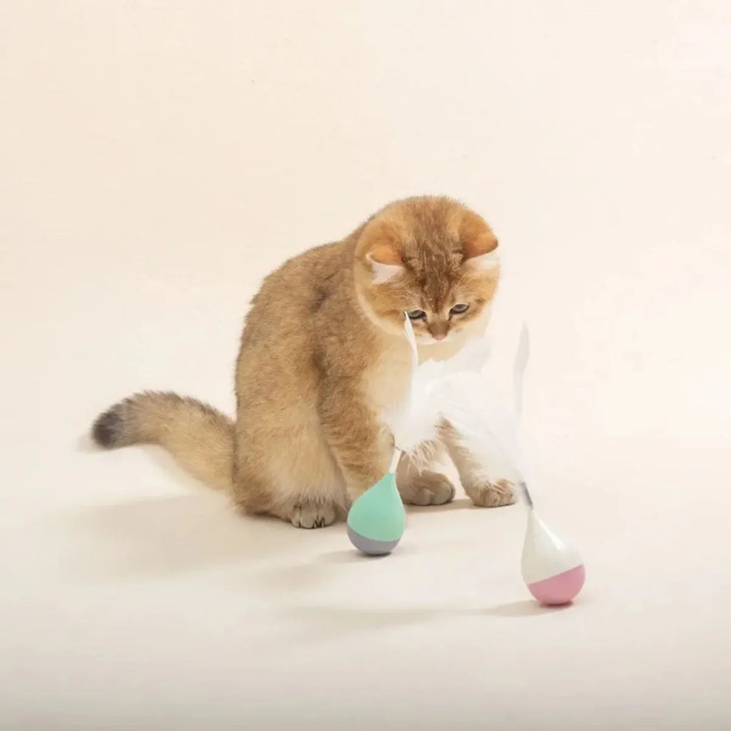 Green and pink feather tumbler cat toy with tease ball on stick