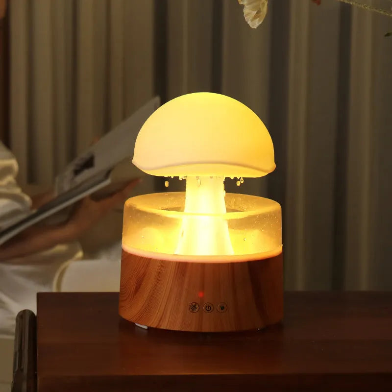 White cloud rain humidifier with rainfall simulation and LED lighting on wooden surface