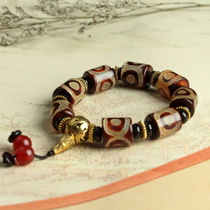 Agate Tibetan dzi bead bracelet with three-eye design and polished finish