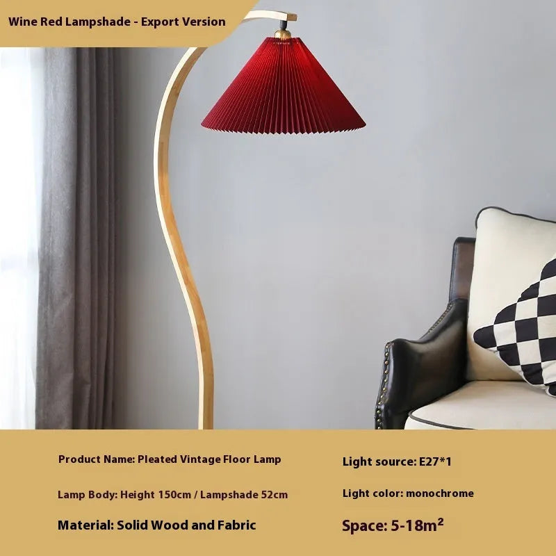 Retro vertical table lamp with tall stand and choice of log white or wine red shade on a bedside table.