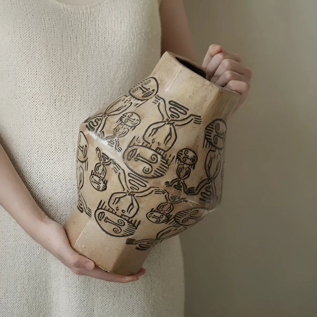Hand-painted ceramic vase with vintage carved religious patterns in tribal totem colours