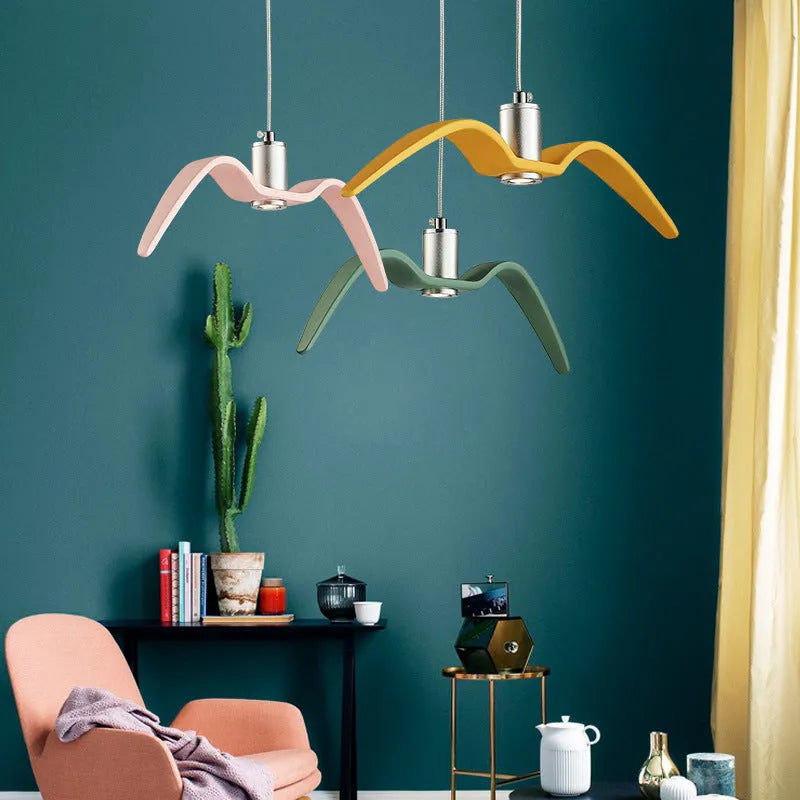 Nordic style ceiling chandelier with macaron colour options shown in a dining room setting.