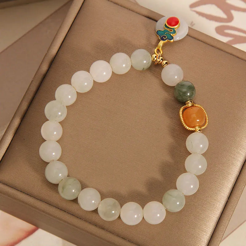 Women's ice jade bracelet with pearl accents and carved Xiangyun peace jade buckle