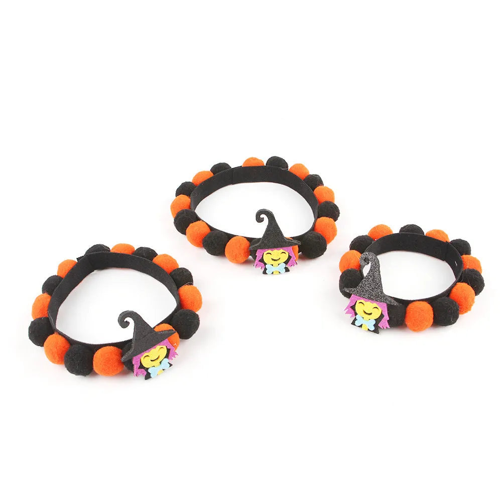 Halloween pet collar with a furry ball accessory in a pumpkin design on a dog's neck.