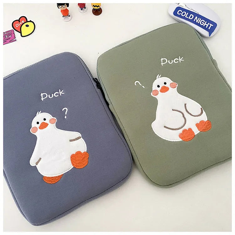 Blue cotton tablet case with embroidered cartoon duck design and zipper opening