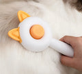 Greenish white cat grooming brush with stainless steel self-cleaning teeth and TPR massage tips