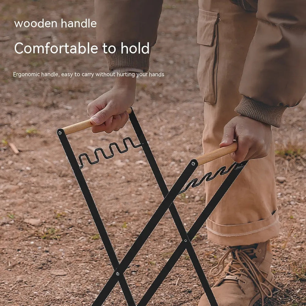 Black folding outdoor trash rack with a wooden handle, holding a rubbish sack.