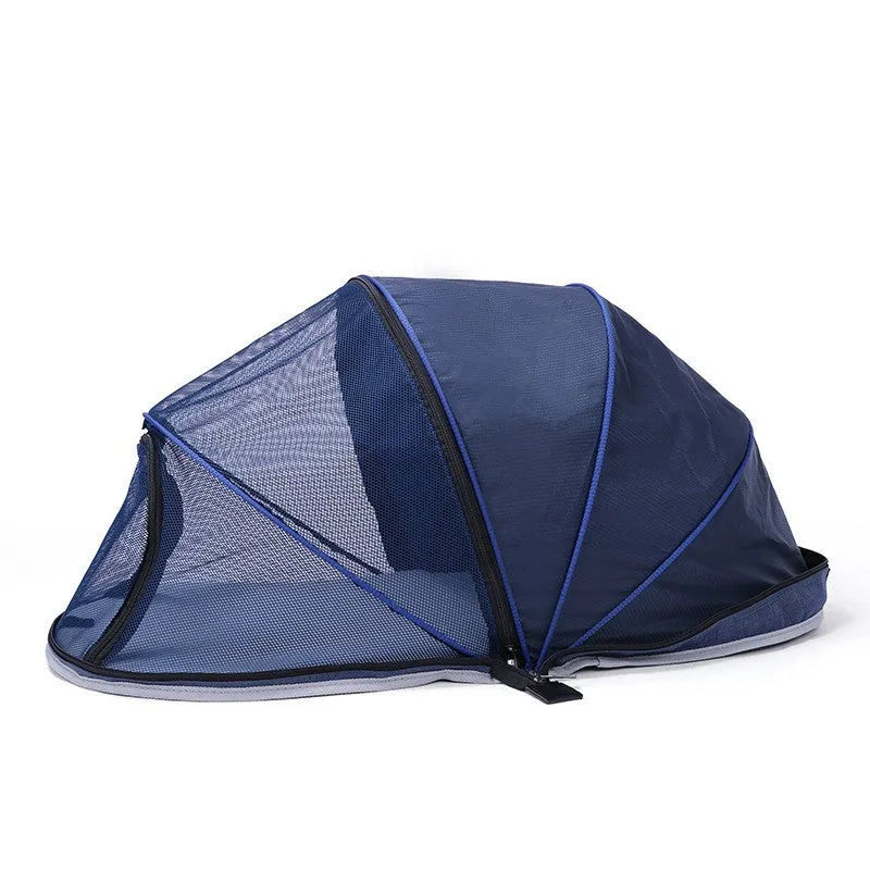Portable folding cloth tent for cats in blue half mesh variant, set up as a travel bed.