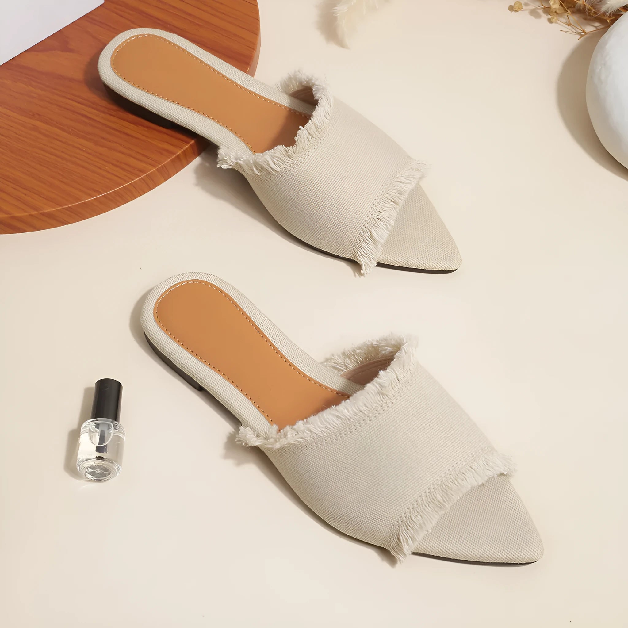 Women's denim flat slippers with a tassel, shown in available colours like apricot, black, and wine red.