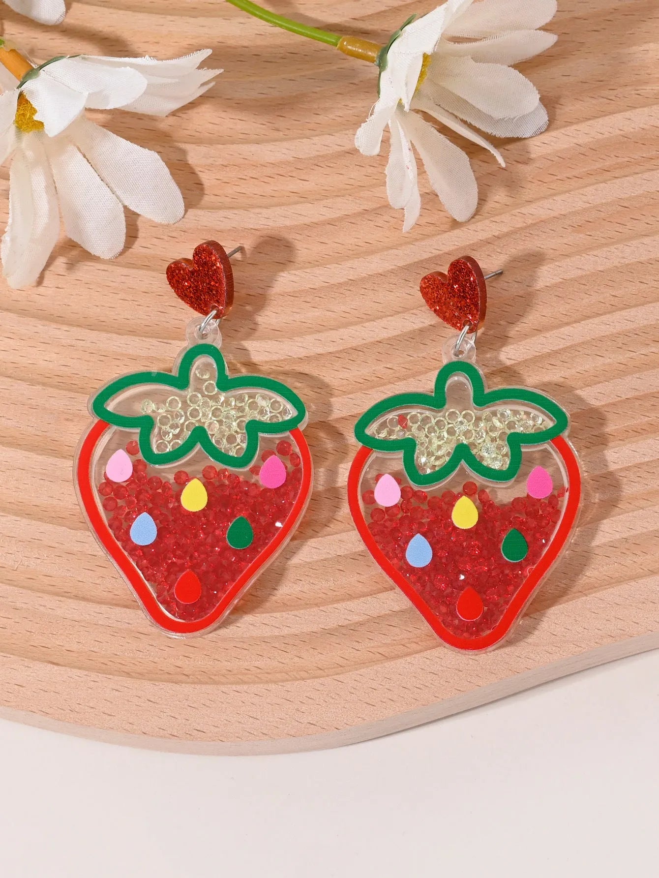Colourful acrylic novelty earrings shaped like fruits and desserts including cherry, strawberry, and ice cream.
