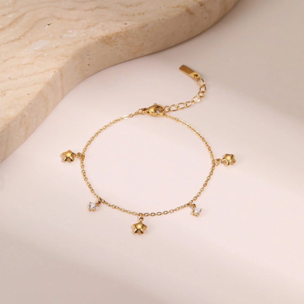 Women's stainless steel bracelet with 18K gold plating and a geometric hexagonal star zircon pendant.