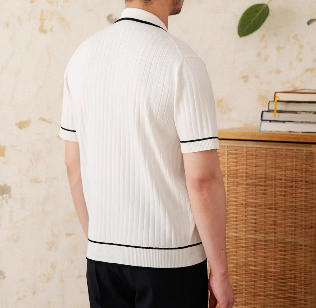 Slim fit black polo shirt with short sleeves and a lapel collar on a mannequin.