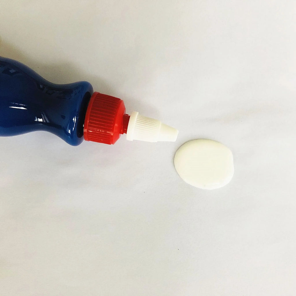 Small blue automotive scratch repair agent bottle with wiping tool for car paint scratch removal