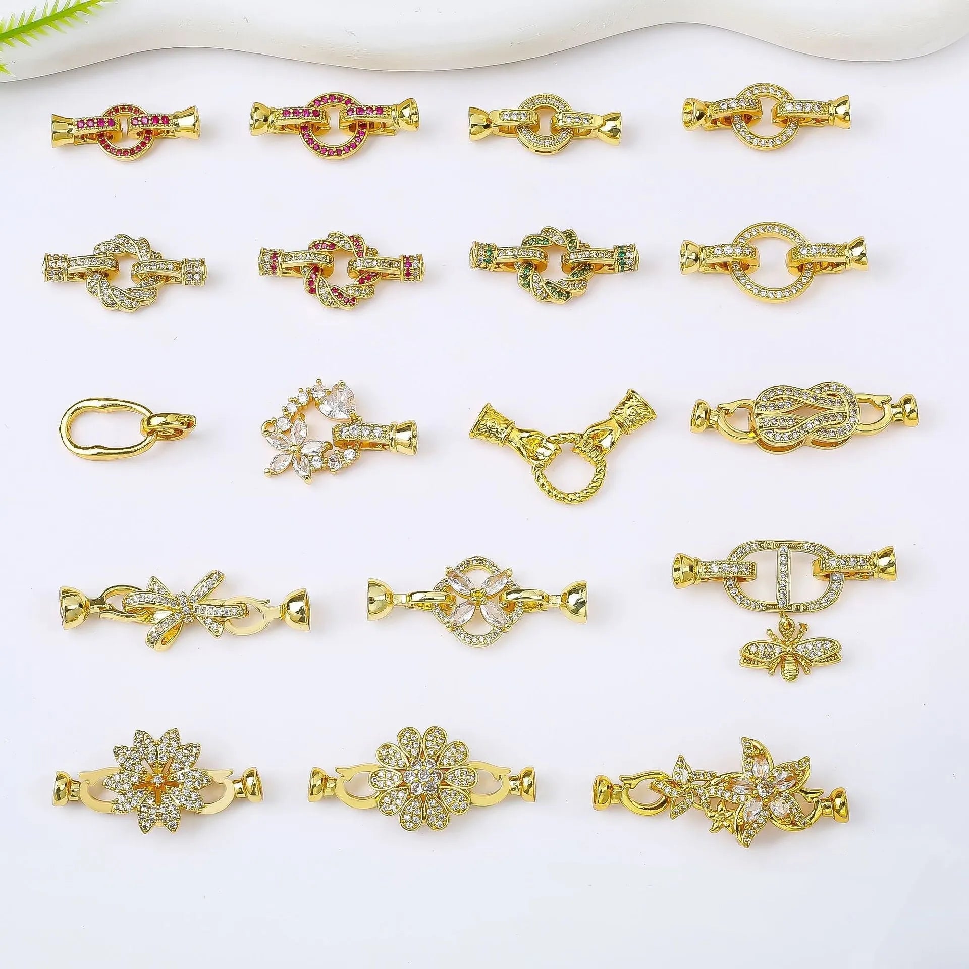 Small gold colour necklace clasp buckle for DIY jewellery on a white background.