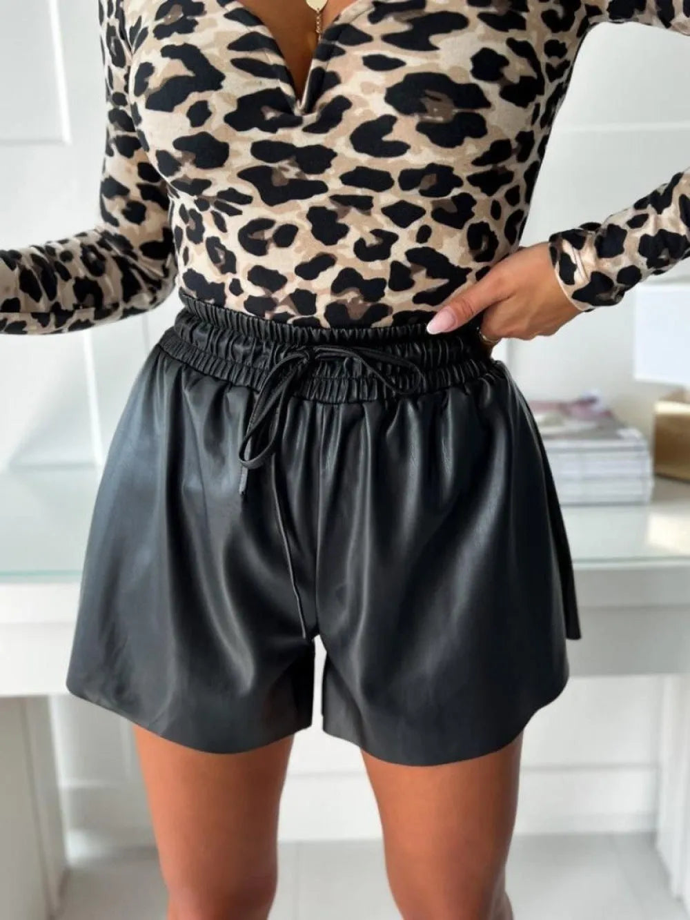 Women's black casual shorts with lace trim detail and wide-leg silhouette