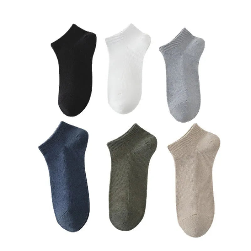 A pair of solid colour low-cut boat socks made from breathable polyester, shown in one of six available colour options.