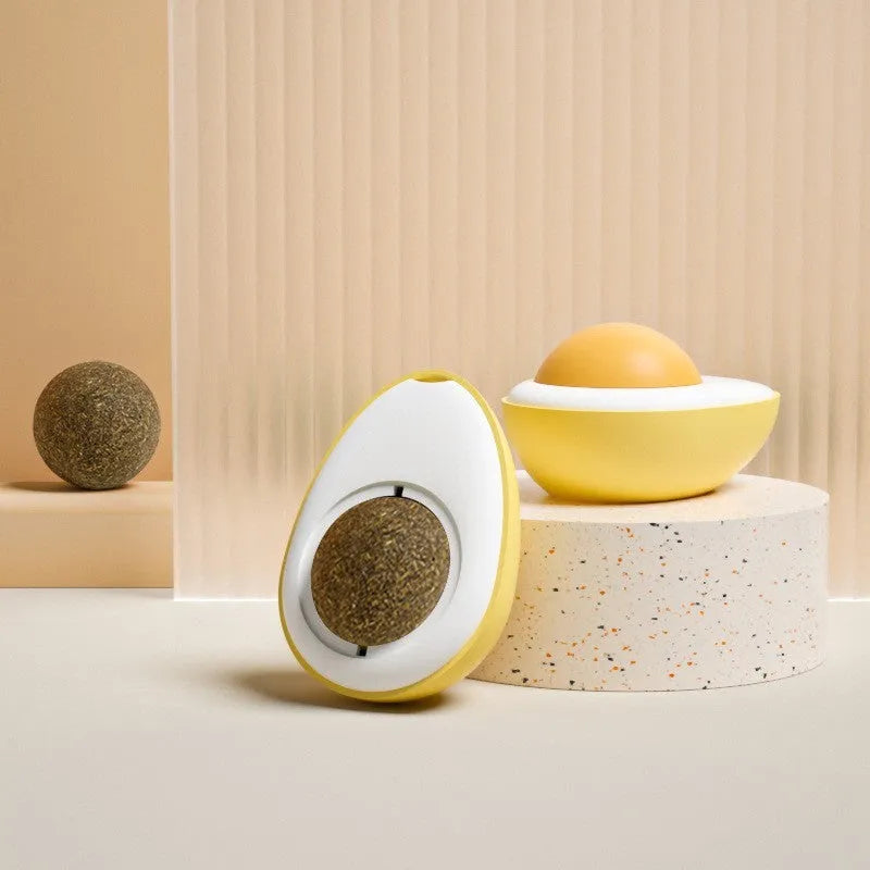 Soft plush catnip ball toy in fried egg shape stuck to a wall, with a cat playing.